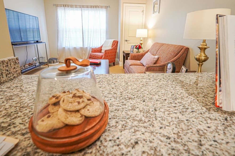 A cozy living room with cookies on a granite countertop.