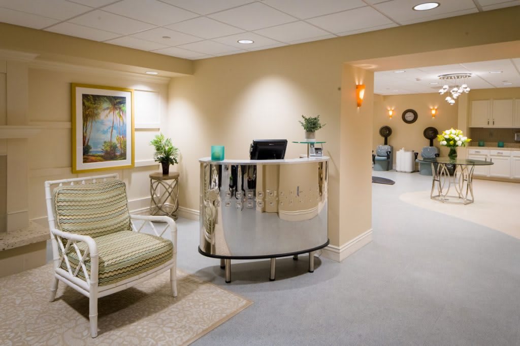 A modern reception area with a curved desk and comfortable seating.