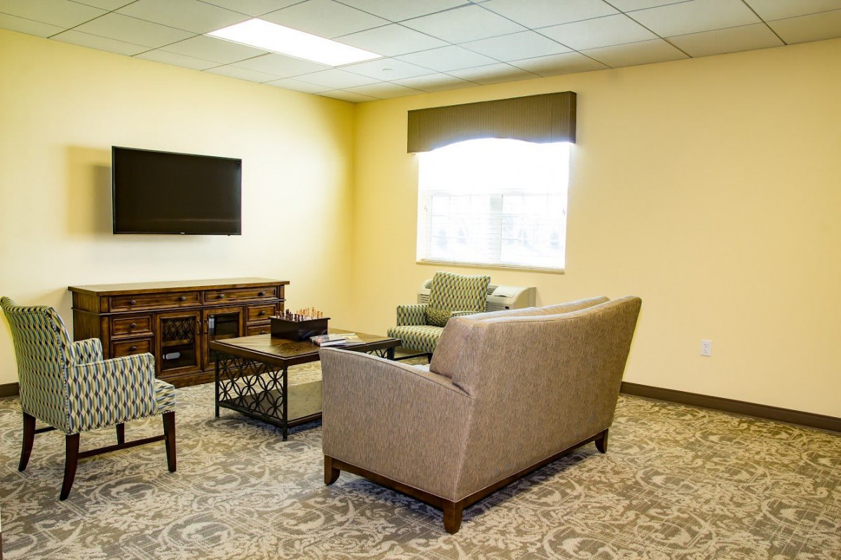 A cozy living room with modern furnishings and a large window.