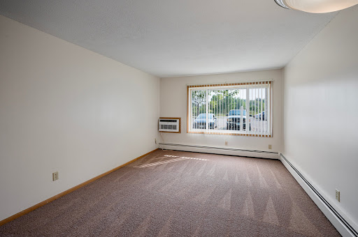 A spacious and bright living room with large windows, inviting natural light.