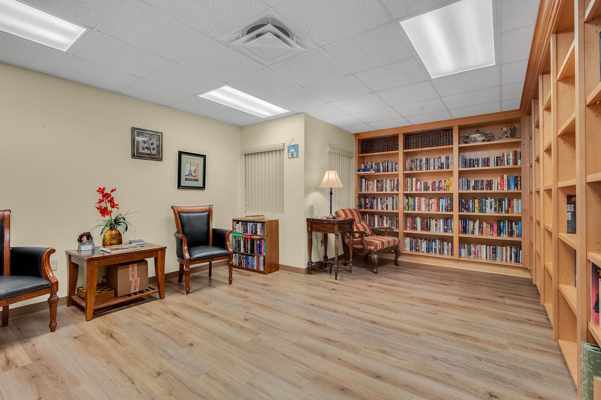 A cozy library corner with bookshelves and comfortable seating.