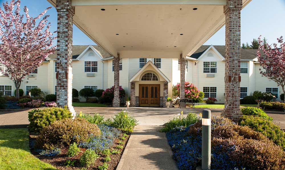 A welcoming entrance of a residential or commercial building with landscaped gardens.
