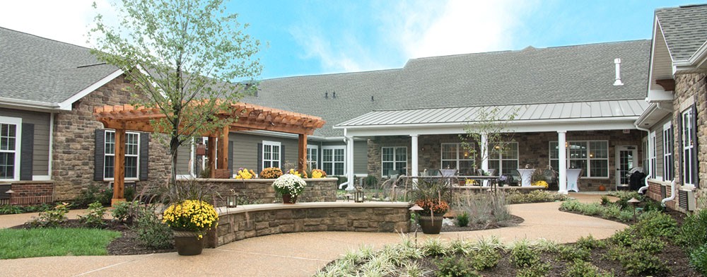 A beautiful house with a landscaped garden and patio area.