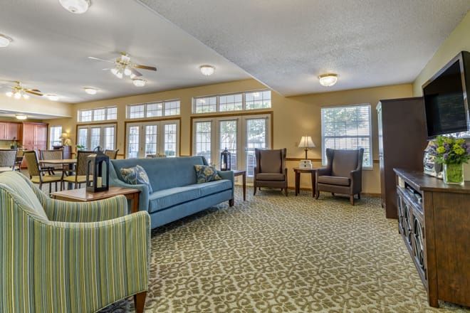 A cozy living room with comfortable seating and large windows.
