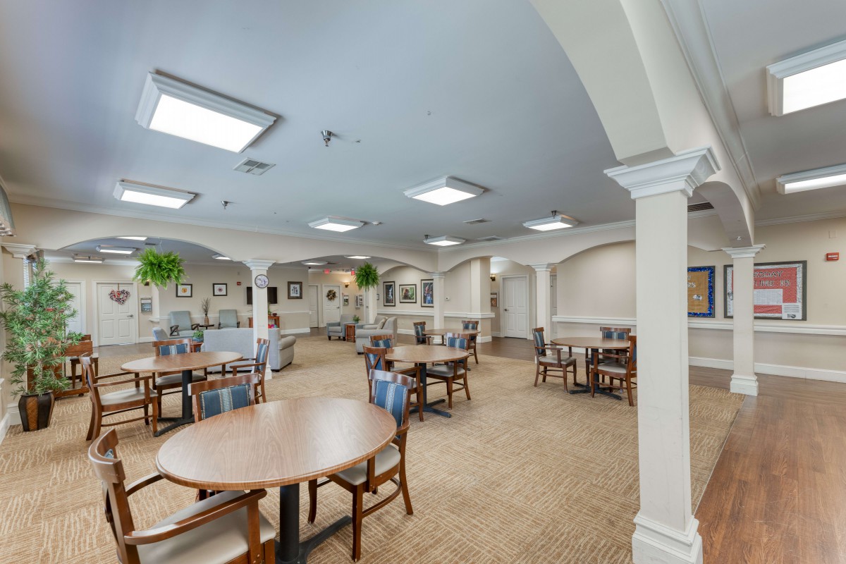 A spacious, well-lit dining area with multiple tables and chairs arranged in an orderly fashion.