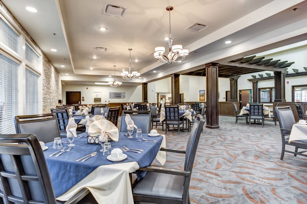 Elegant dining room with neatly set tables and comfortable seating.
