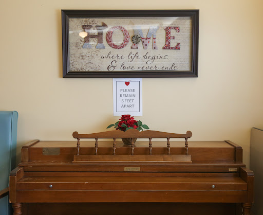 A cozy home entrance featuring decorative wall art and a wooden piece adorned with flowers.