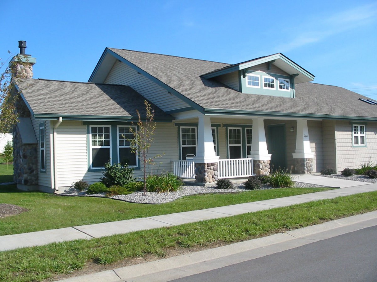A suburban house with a neatly maintained lawn and a front porch.