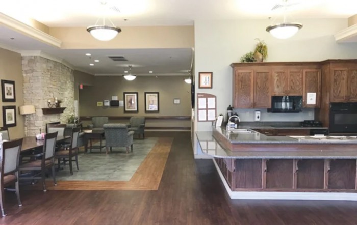 A cozy interior featuring a kitchen and dining area with wood flooring and soft lighting.