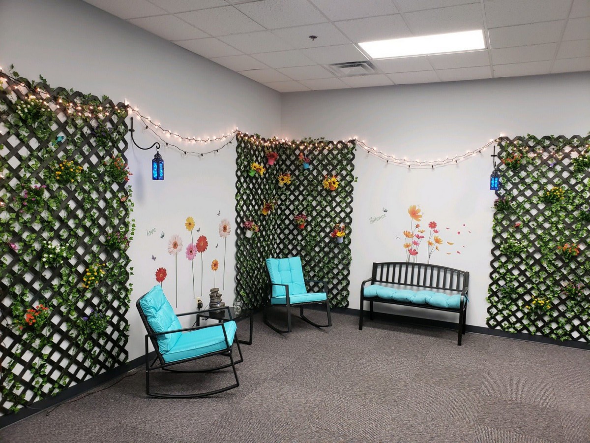 Cozy seating area with turquoise-cushioned furniture and decorative lattice walls adorned with string lights.