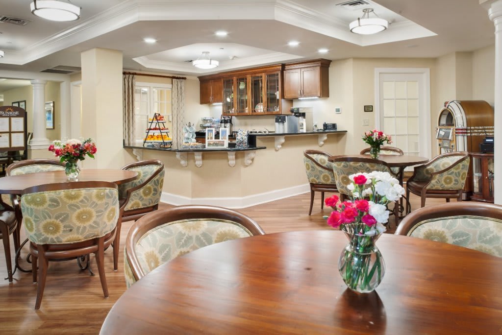 A cozy dining area with elegant wooden furniture and a view of the kitchen counter.