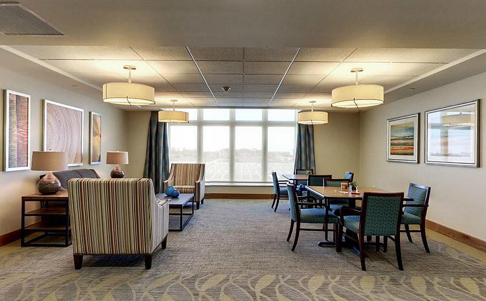 A spacious living room with comfortable seating and large windows.