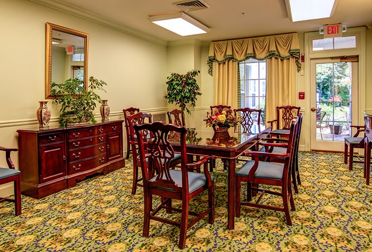 A cozy dining room with elegant furniture and decorative elements.