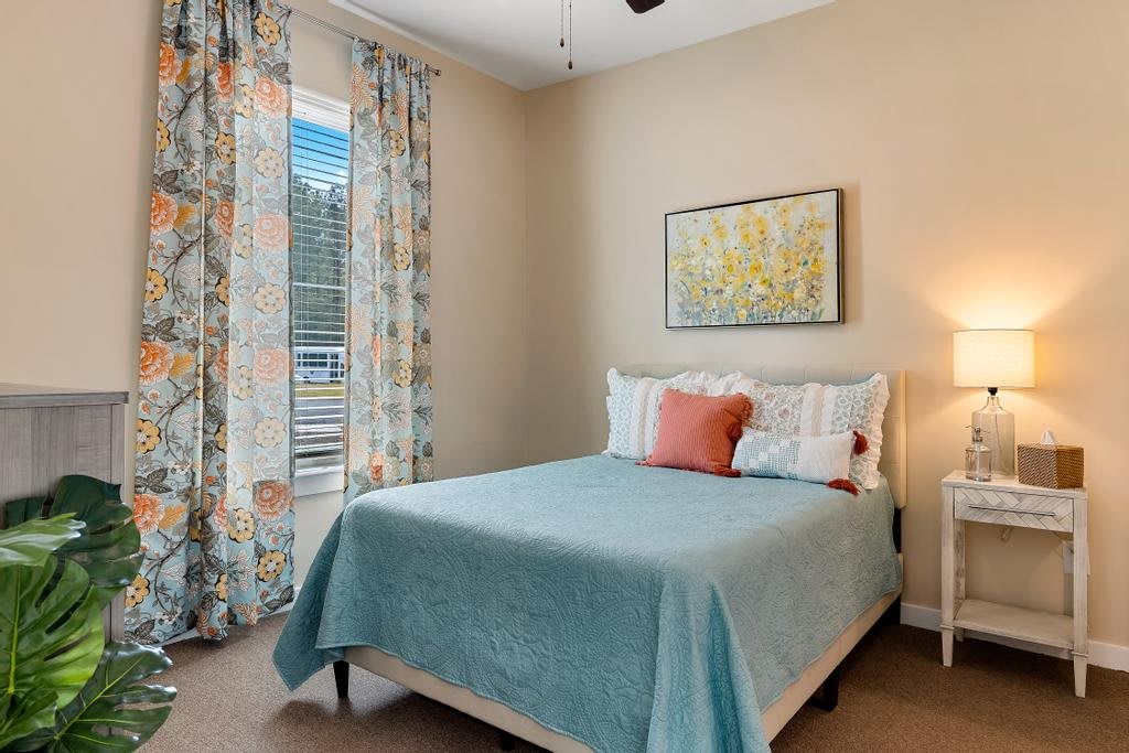 A cozy bedroom with a neatly made bed, soft pastel colors, and elegant decor.