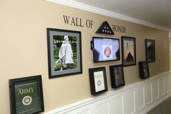 A Wall of Honor showcasing military memorabilia and framed photographs.