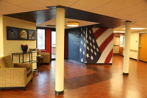 An inviting lobby space featuring an American flag mural and comfortable seating areas.