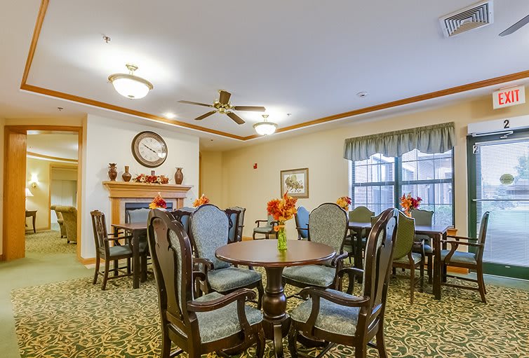 A cozy dining room with elegant furniture and a fireplace.
