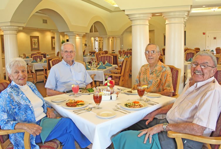 A group of elderly people enjoying a meal together in a restaurant setting.