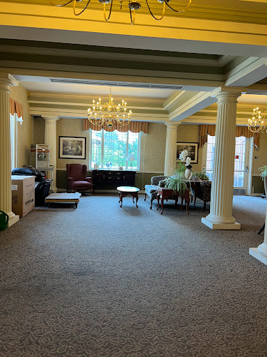 A spacious and elegantly designed lobby area featuring stylish furniture and decorative chandeliers.