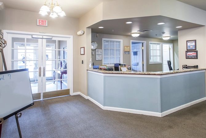 A reception area with a desk and entrance doors.