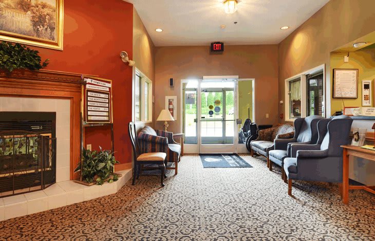 A cozy lobby with comfortable seating and warm lighting.