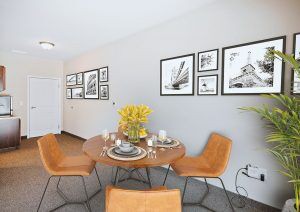 A modern dining room with stylish furniture and framed wall art.