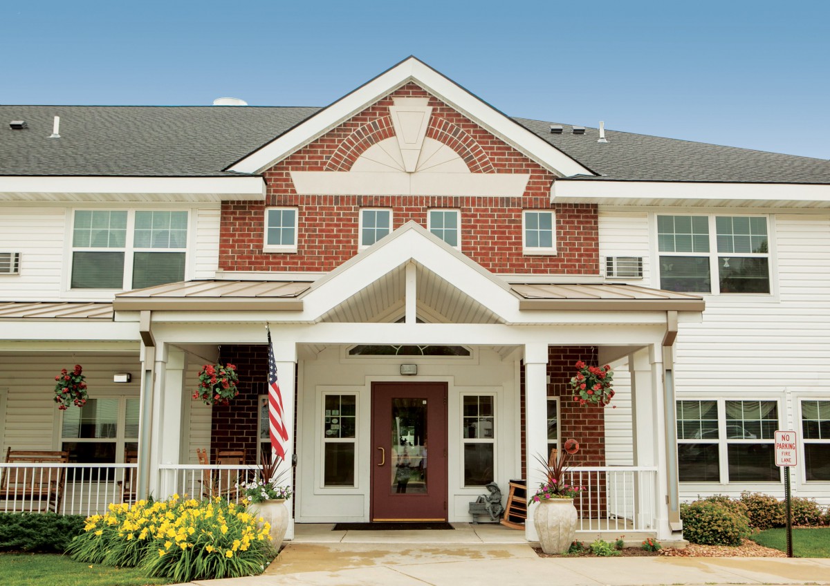 A residential building with a brick exterior and a welcoming entrance.