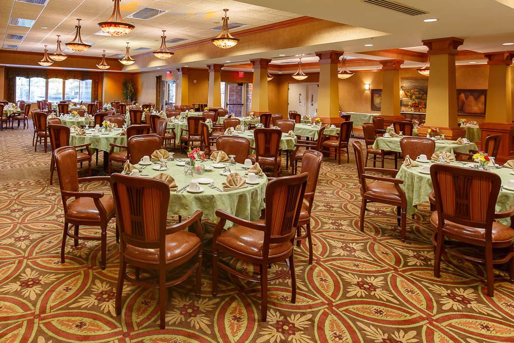 An elegant dining room with multiple tables set for guests.