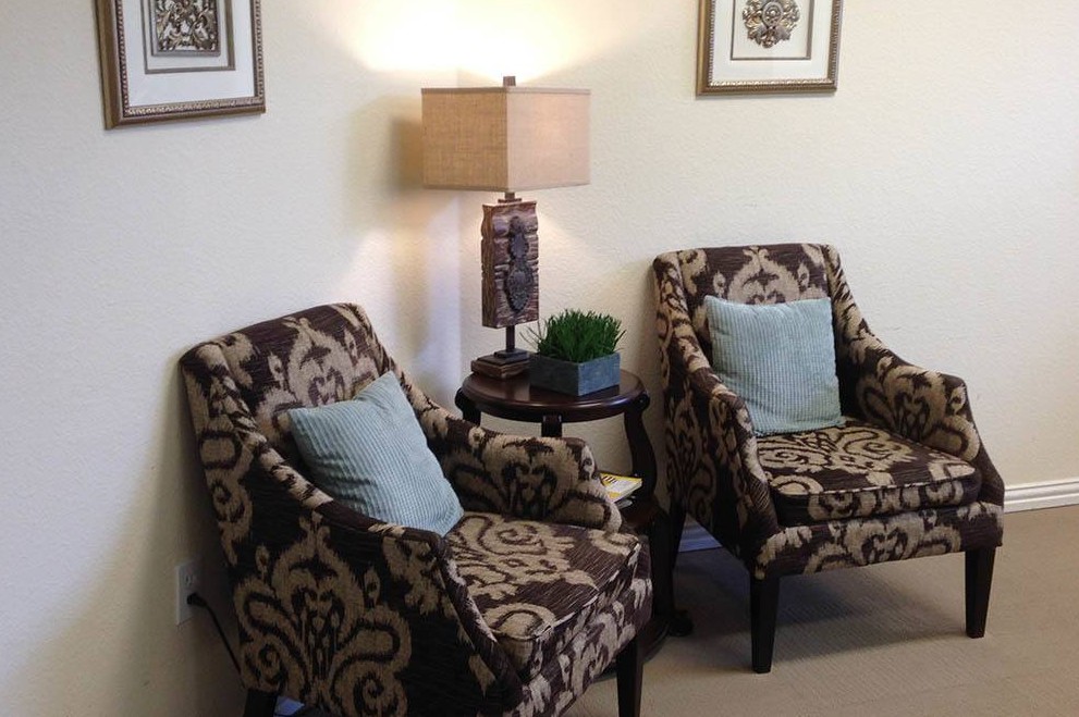 A cozy living room setup with patterned chairs and a stylish lamp.