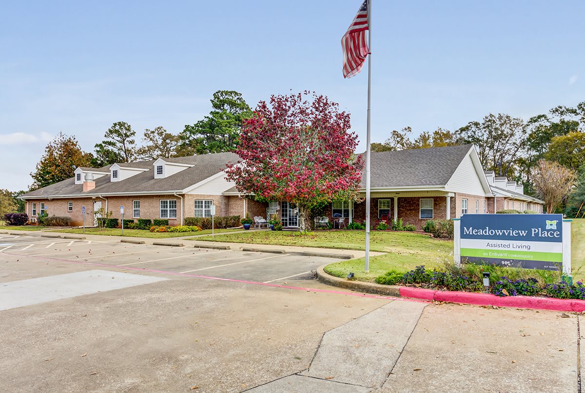 A single-story building with an American flag in front and well-maintained landscaping.