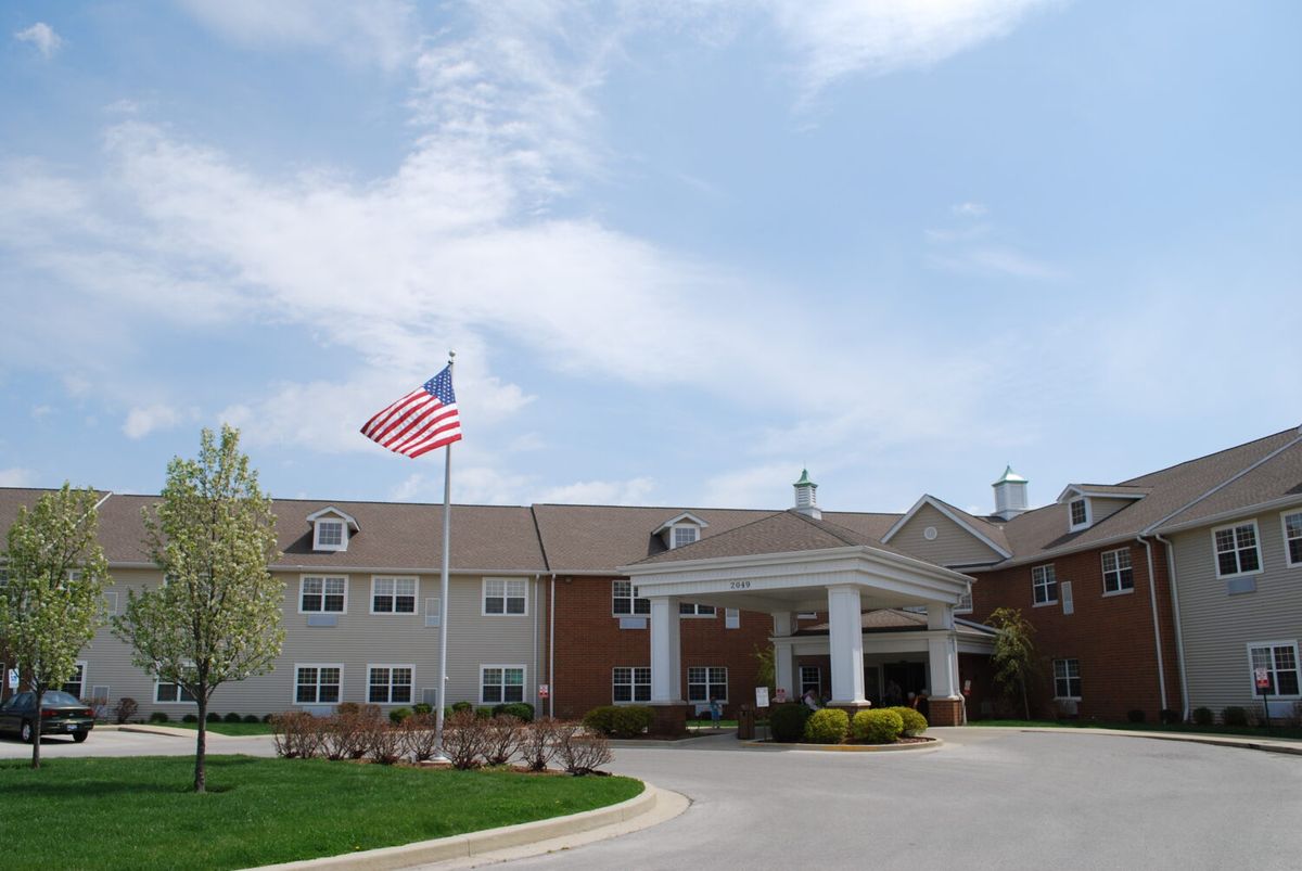 A building with an American flag at the entrance on a sunny day.