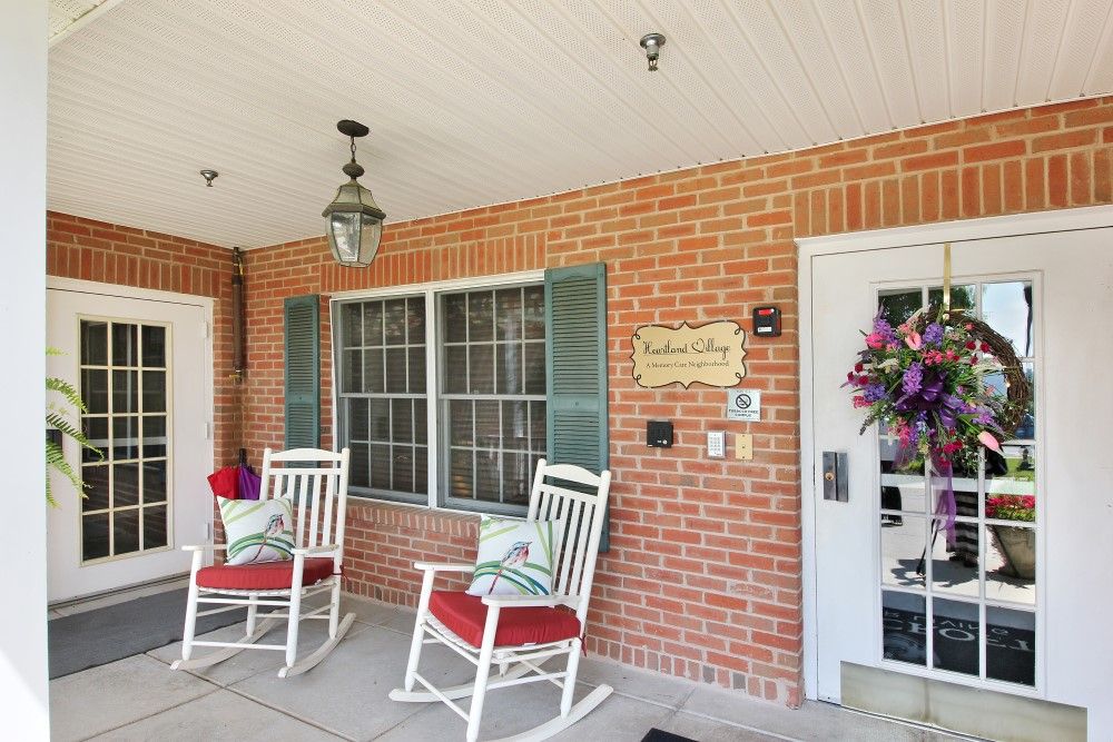 A cozy porch with rocking chairs and a welcoming decoration.
