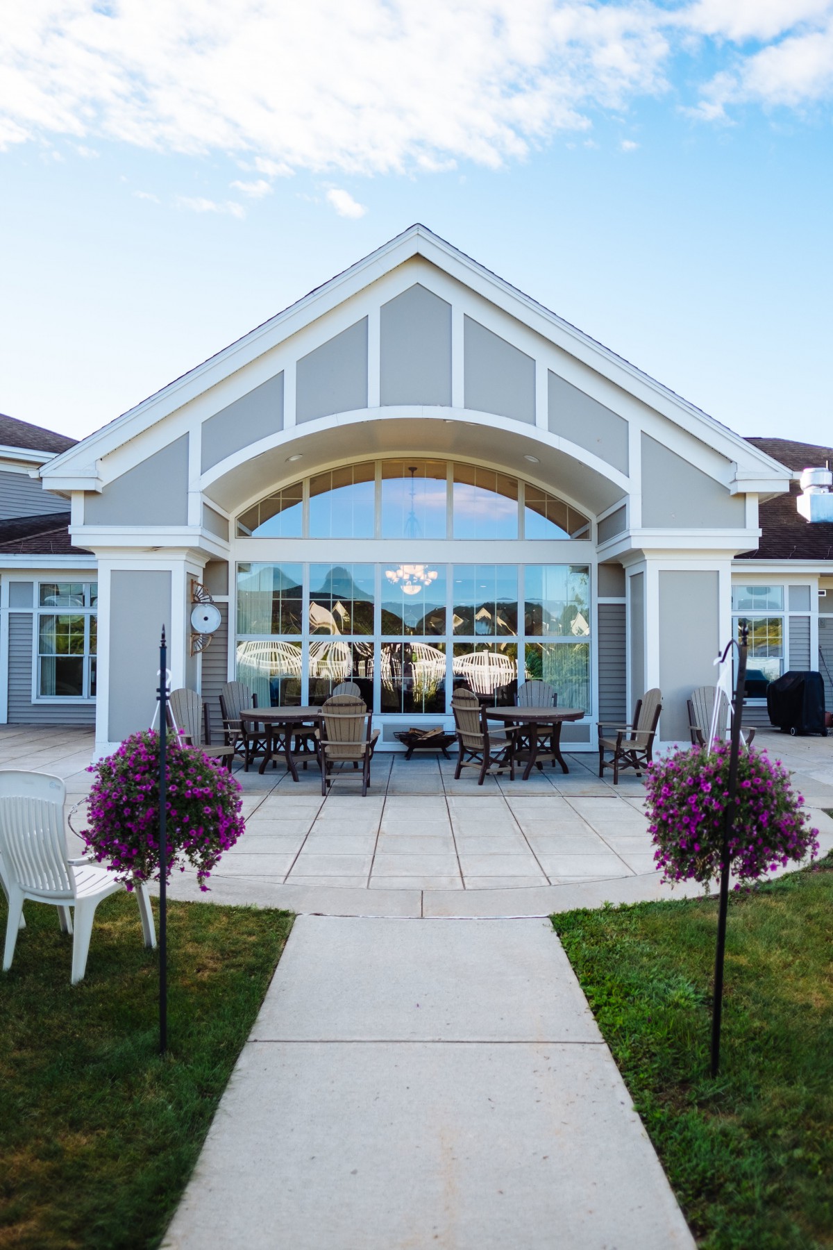 A modern house featuring an inviting patio with outdoor seating and well-maintained landscaping.