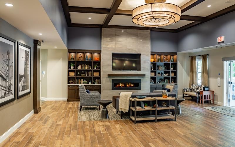 A modern living room with a fireplace, elegant seating, and stylish decor.