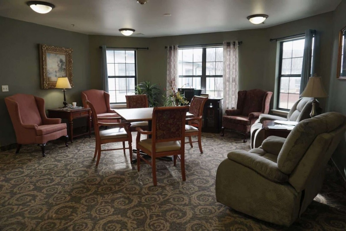 A cozy living room with comfortable seating and a central table.