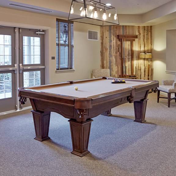 A well-furnished game room featuring a classic pool table.