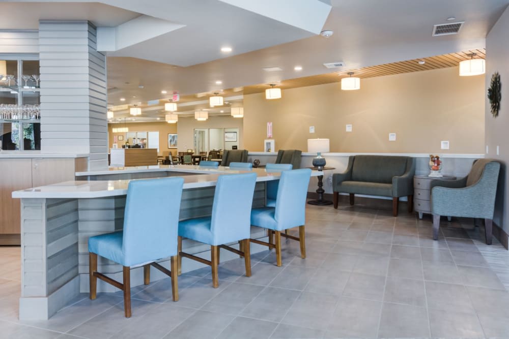A modern seating area with blue chairs and stylish lighting.