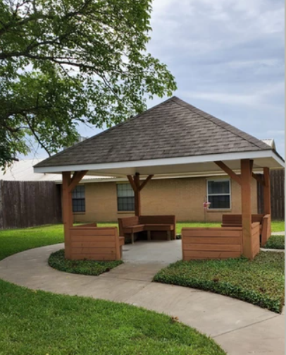 A charming gazebo surrounded by lush greenery, perfect for relaxation or gatherings.