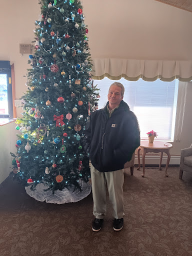 A cheerful moment captured by the beautifully decorated Christmas tree.