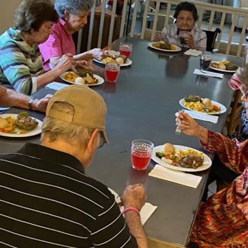Seniors enjoying a meal together in a communal setting.