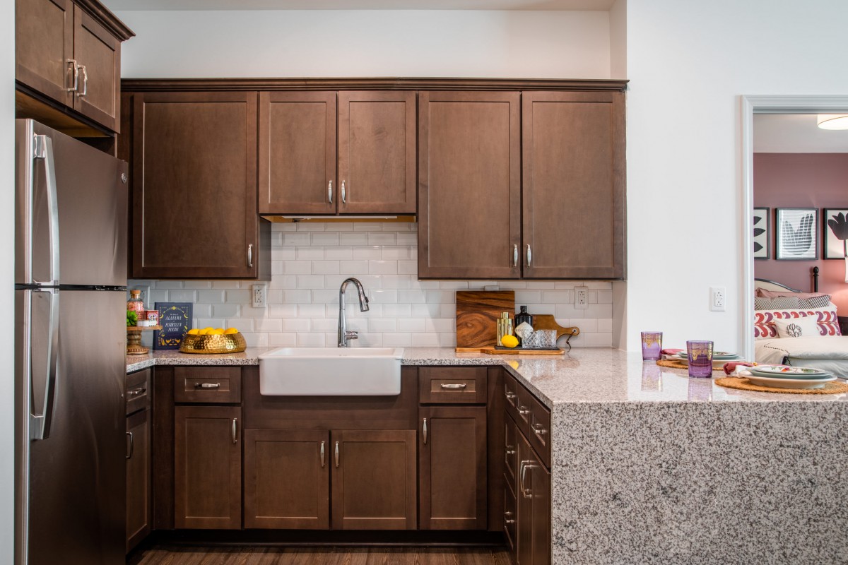 A modern kitchen with wooden cabinets and a farmhouse sink.