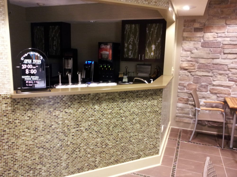 An indoor bar area with a counter and beverage dispensers.