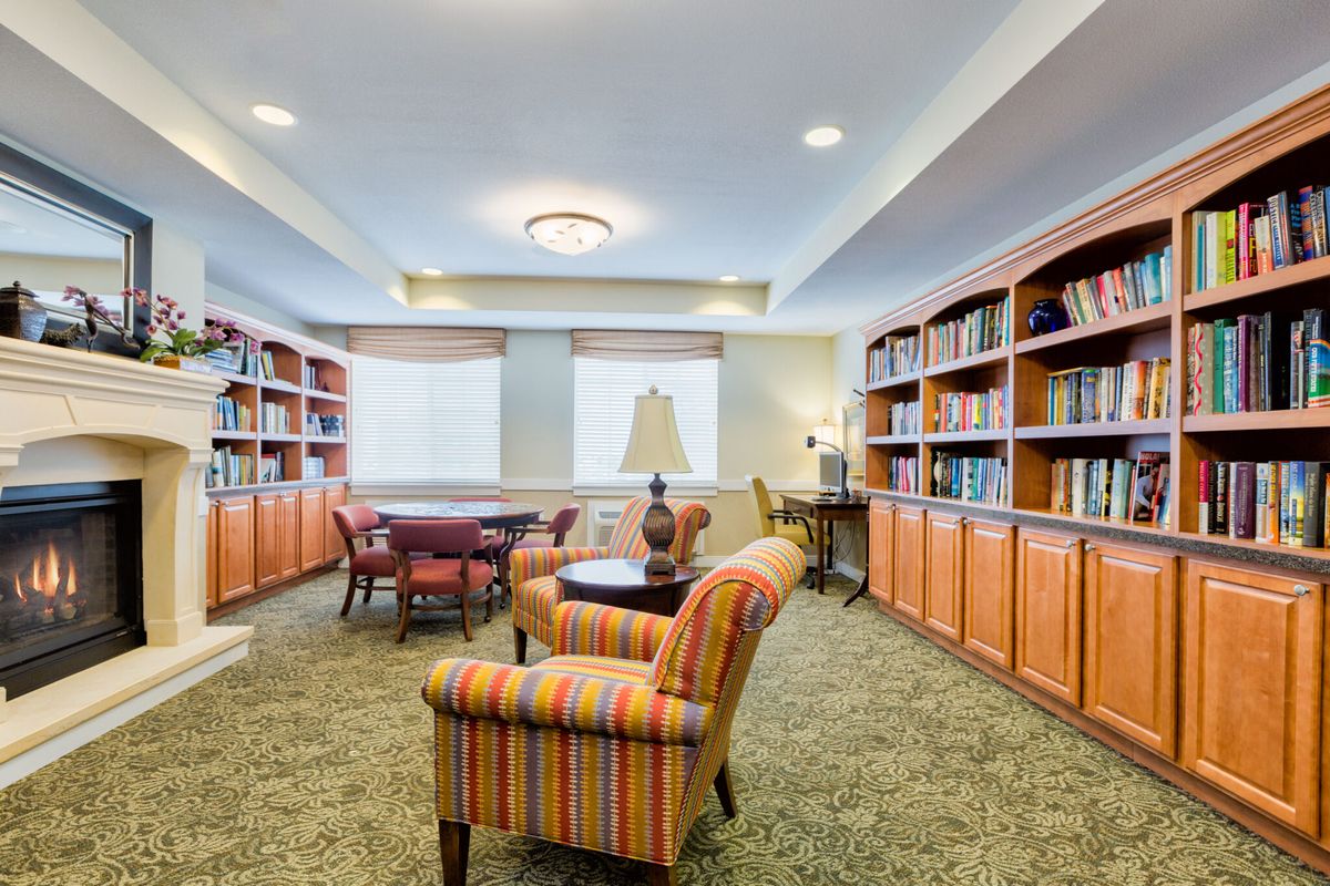 A cozy library with armchairs and bookshelves.