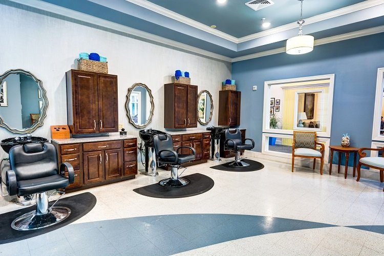 A modern hair salon interior with styling stations and a waiting area.