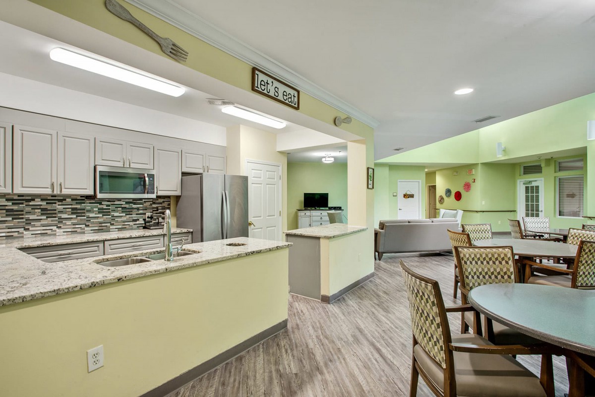 A modern kitchen and dining area with bright lighting and contemporary decor.