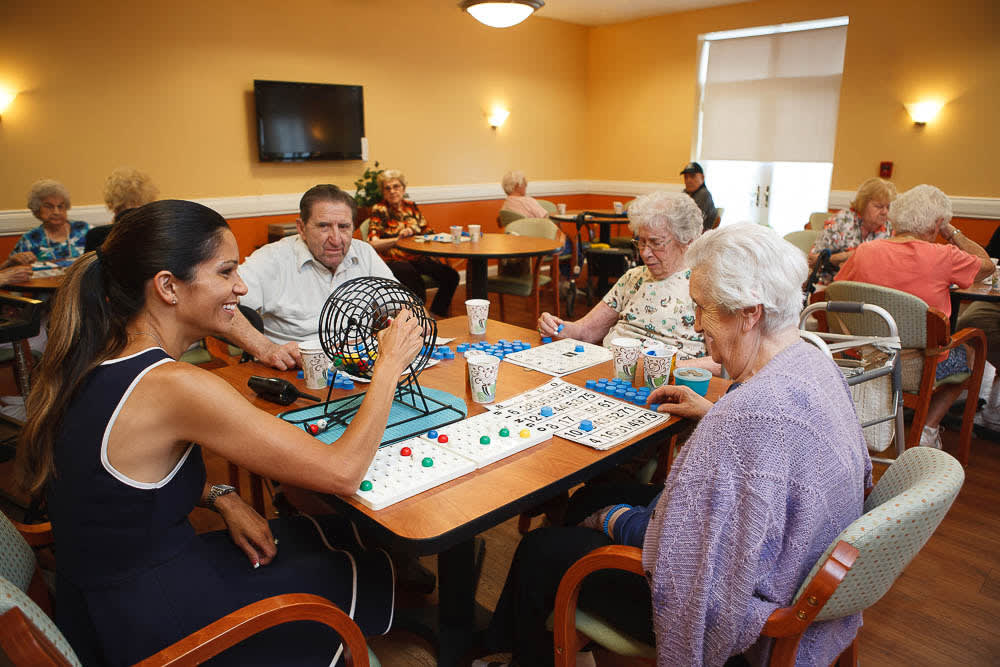 A group of people playing bingo together in a community center.