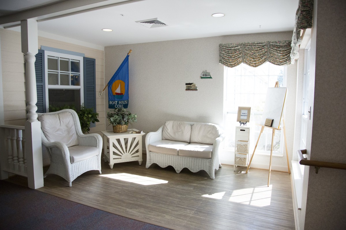 A cozy living room with wicker furniture and warm sunlight streaming through the window.