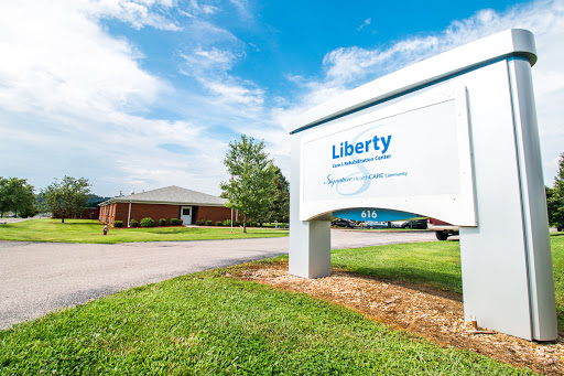 A view of the Liberty sign in front of a building on a clear day.