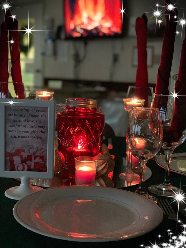 A romantic table setting with glowing candles and elegant glassware.