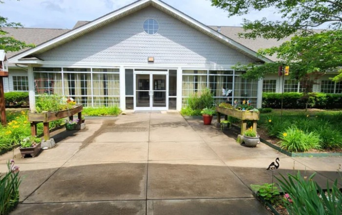 A welcoming building entrance adorned with plants and greenery.